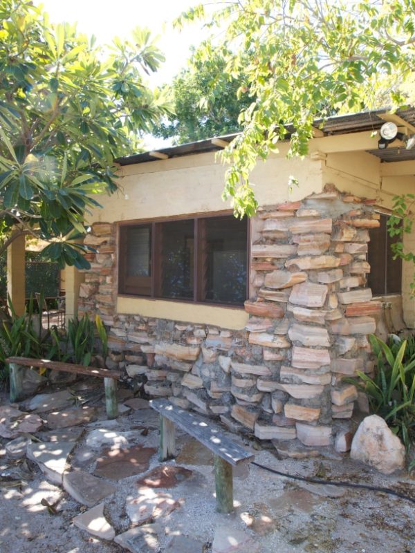 A Stone House External photo showing the unique design of the accommodation, as well as the native tropical plants and trees surrounding the house.
