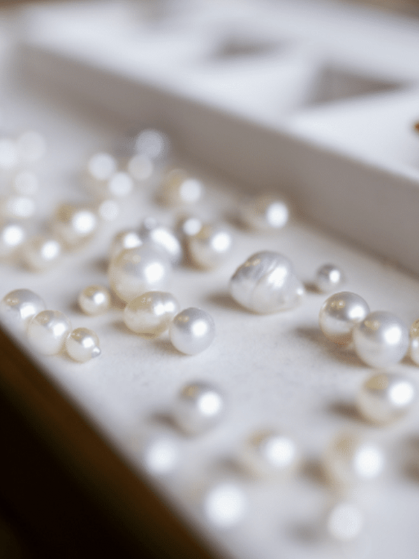 An assortment of Australian pearls, grown at both our Cygnet Bay and Broken Bay pearl farm, sit of a tray ready to be inspected during a Pearl grading experience available at Cygnet Bay Pearl Farm.