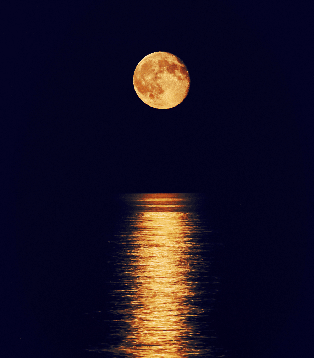 The moon glows in the velvet, dark sky, and is perfectly positioned to create the phenomenon known as "Stair Case to the Moon" which can be best seen at Cygnet Bay Pearl Farm.