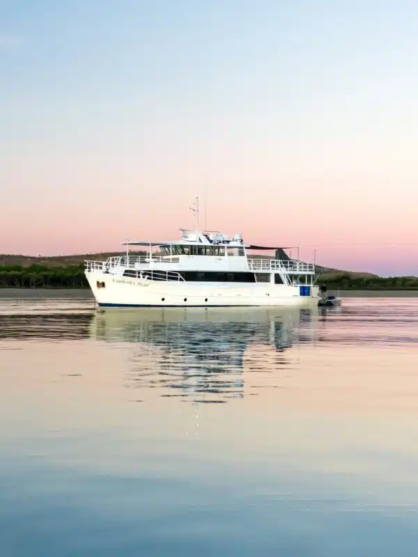 The Kimberley Day Cruise vessel called the Ohana, sits on the calm sea while it's guests enjoy the beautiful sunset.
