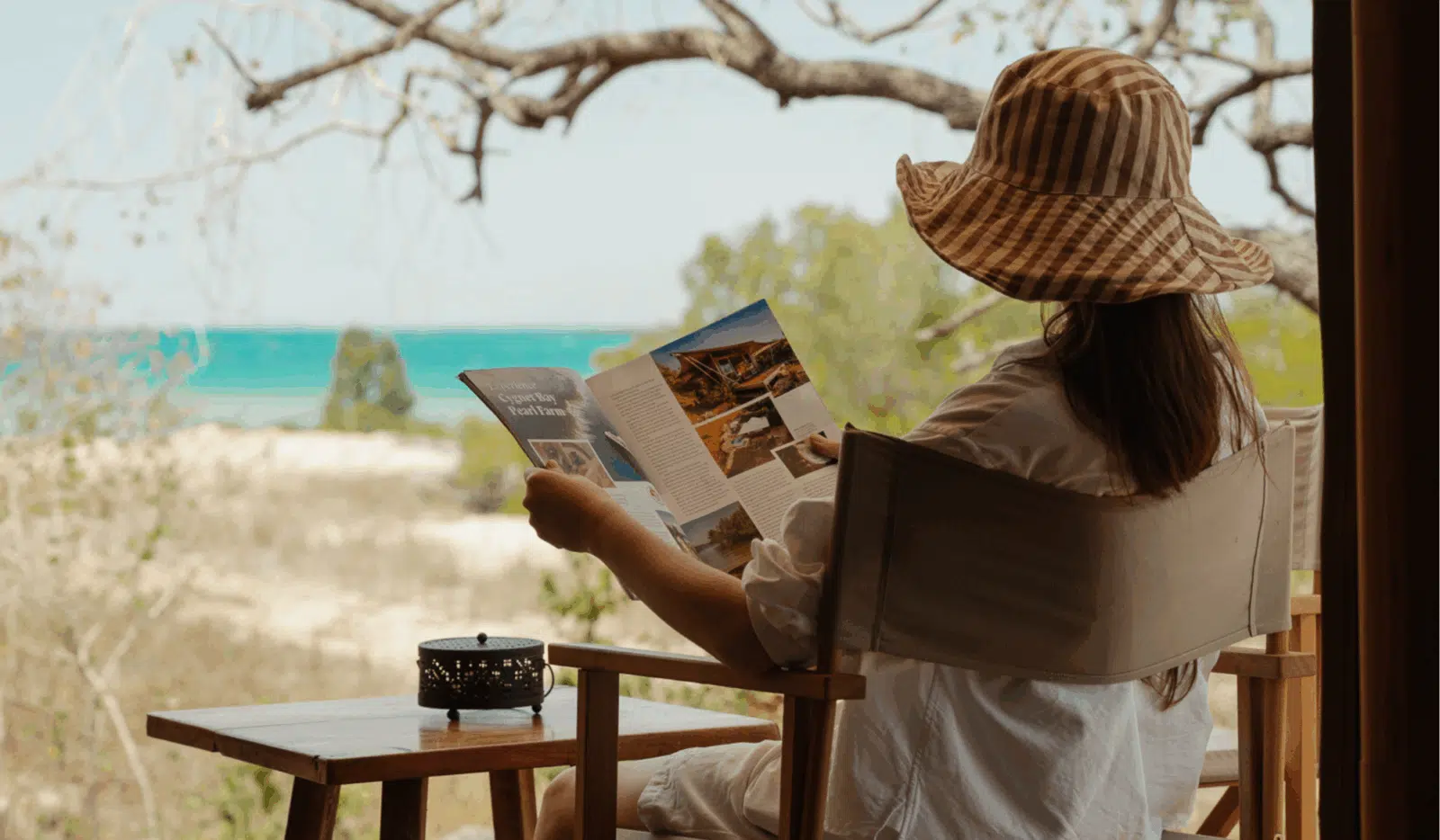 The Bayview Safari Tent Beds side by side in the tent, with a wall fan in the corner to keep cool. In the distance is the blue waters of Cygnet Bay, only a short walk away.