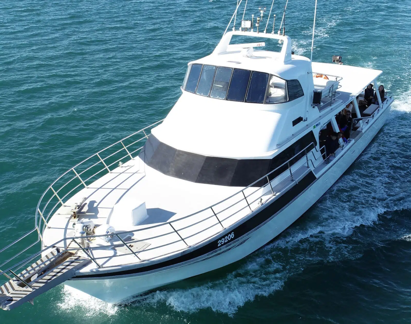 A white boat sits on the blue Cygnet Bay waters, ready to embark on a tour.