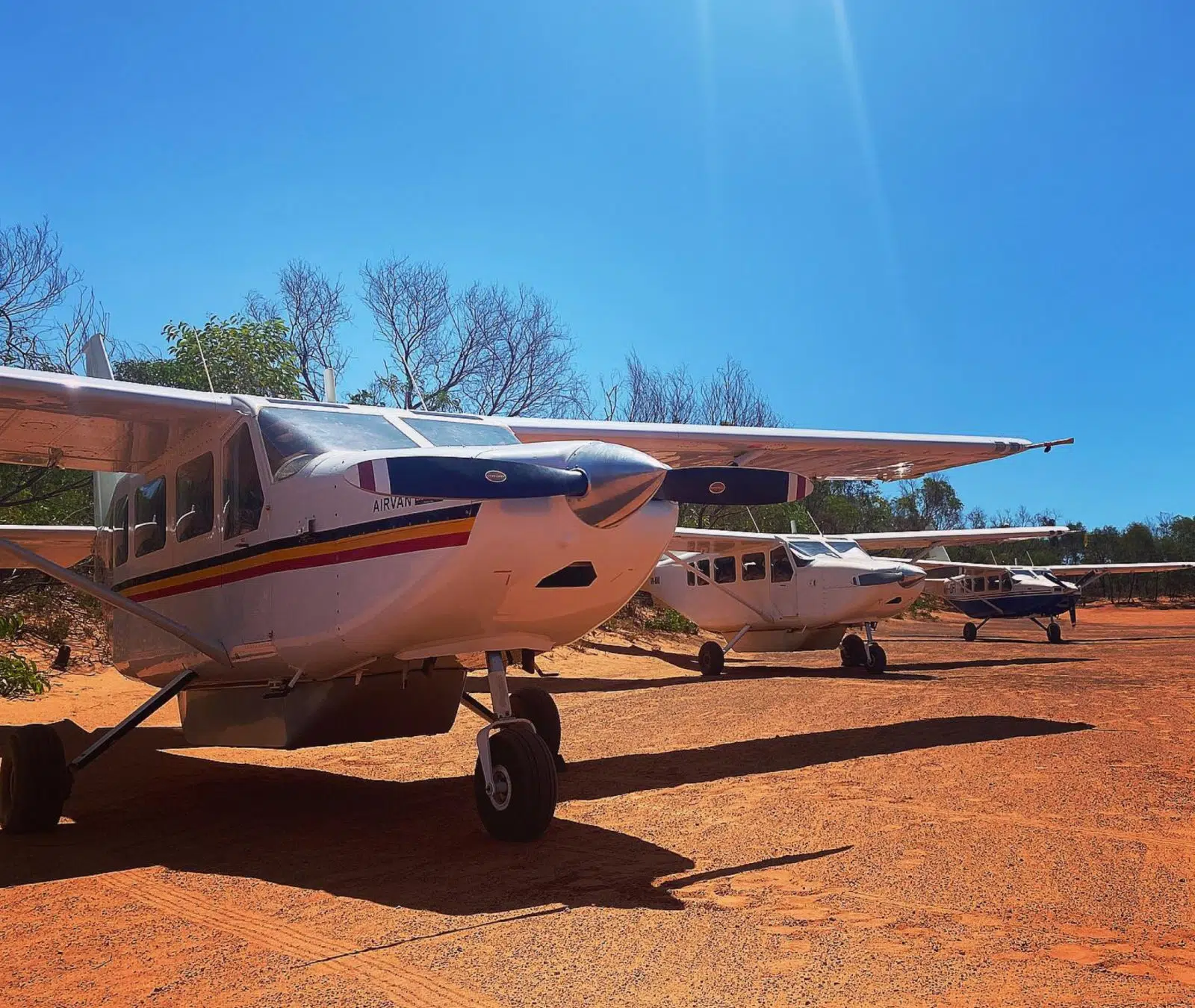 Three planes sit on the ground, ready for guests to enjoy the stunning weather and sights of the Kimberley and Buccaneer Archipelago from above.