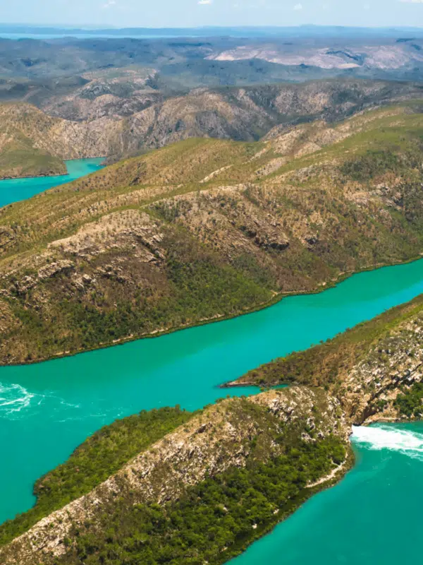 On a helicopter, the passenger enjoys the beautiful views of the Kimberley - the white sandy beaches, lush green foliage and turquoise waters.