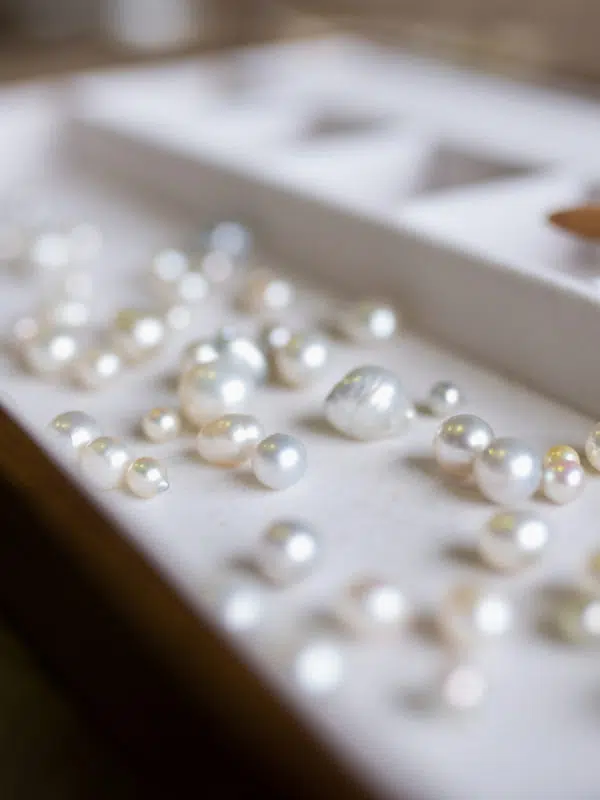 An assortment of Australian pearls, grown at both our Cygnet Bay and Broken Bay pearl farm, sit of a tray ready to be inspected during a Pearl grading experience available at Cygnet Bay Pearl Farm.